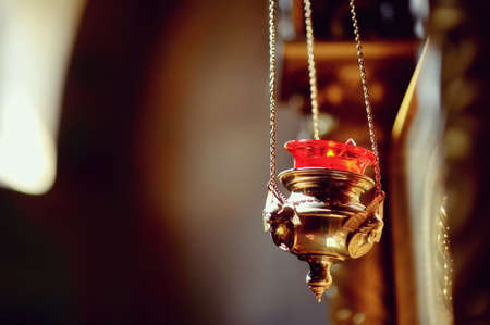 on an abstract background of a gold chain hanging on a lamp with fire