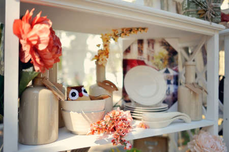 on a rack set of beautiful dishes with decorations and flowers