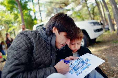 Outdoors enthusiastically father and son were cut with scissors imageの写真素材