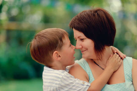 Portrait of an affectionate and loving mother kissing her baby sonの写真素材
