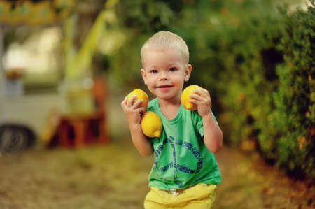 on the nature of the little boy in green t-shirt with mature lemons