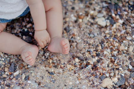 summer on the beach little baby bare feetの写真素材