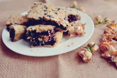 cloth on a white plate with a cake and rosebuds