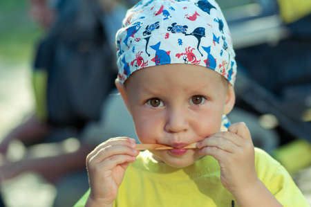 cute little boy licking ice cream and ate ice cream stickの写真素材