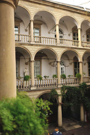 stone balcony with arches and vases with colorful flowersのeditorial素材
