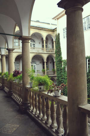 stone balcony with arches and vases with colorful flowersのeditorial素材