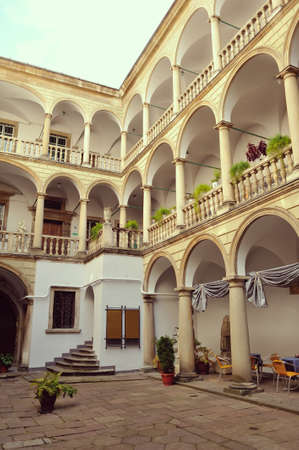 stone balcony with arches and vases with colorful flowersのeditorial素材