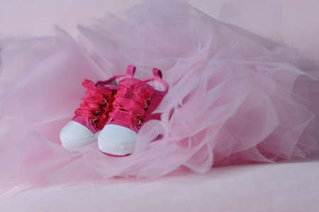 on pink tulle trim red baby shoes with big lacesの写真素材