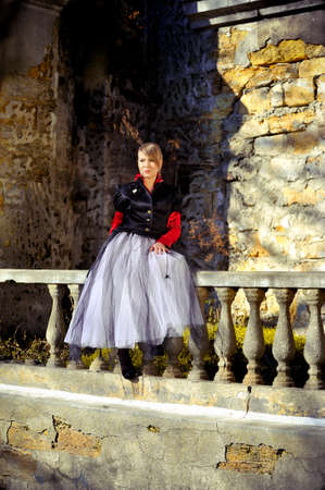 girl posing in lush white skirt a collapsed building near the oldの写真素材