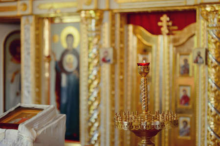 in the temple beautiful gilded icons with burning lampsのeditorial素材