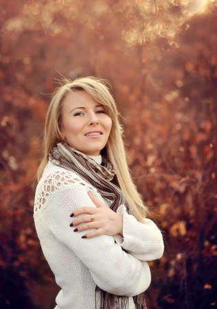 Outdoors portrait of a girl with long blonde hair late autumnの写真素材