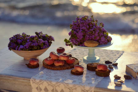sunrise on the beach in the sand is a table with color and peachesの写真素材