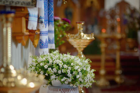 in the church in gold icons with oil lamps candlesticks with candlesの写真素材