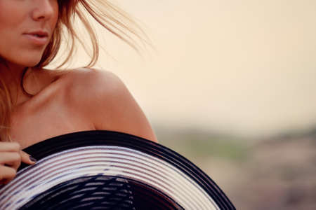 closeup of blond girl with open shoulder and hatの写真素材