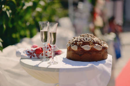 white round spacing wedding loaf and two glasses of champagneの写真素材