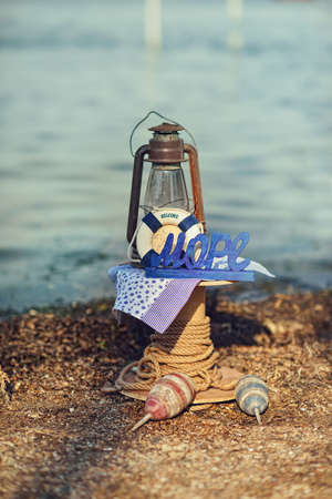 on sea background scenery of a rope with buoys, lantern and lifebuoyの写真素材