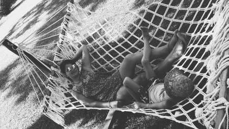 in the summer park with a large hammock mother and sonの写真素材