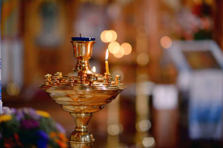 in the church in gold icons with oil lamps candlesticks with candlesの写真素材