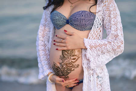 pregnant woman with sea backgroundの写真素材