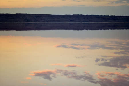 sunset over the river with the image of beautiful cloudsの写真素材