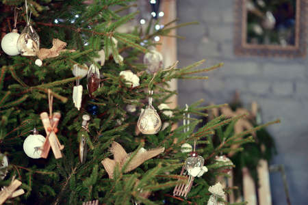 Green Christmas tree decorated with glass and wooden toys rusticの写真素材