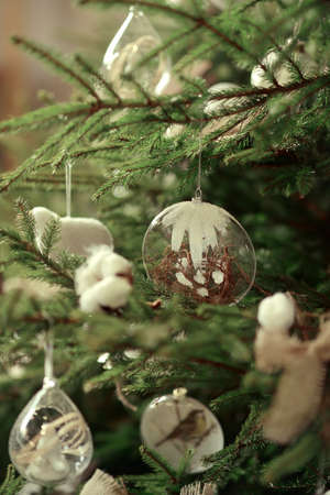 Green Christmas tree decorated with glass and wooden toys rusticの写真素材