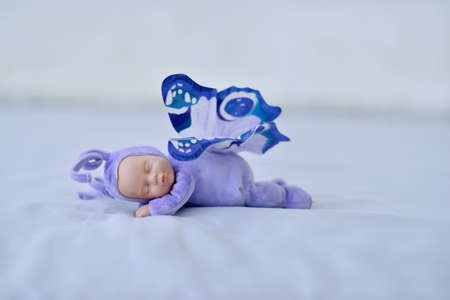 sleeping doll with beautiful purple wings like a butterflyの写真素材