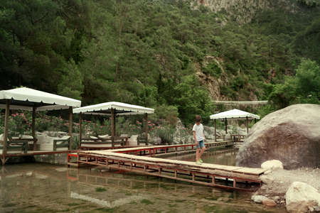 among the mountains on the pond walkway made boards and marqueesの写真素材