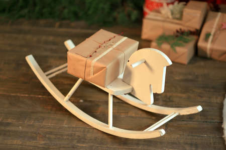 on the wooden floor Christmas tree with presents wooden horseの写真素材