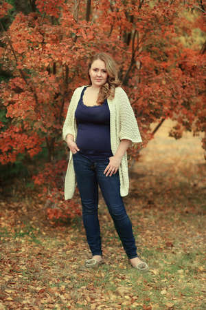 golden autumn in the forest posing beautiful woman with long hairの写真素材