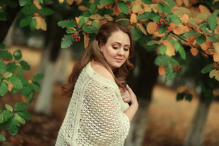 golden autumn in the forest posing beautiful woman with long hairの写真素材