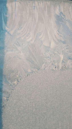 background winter window frost melts and runs down the glassの写真素材