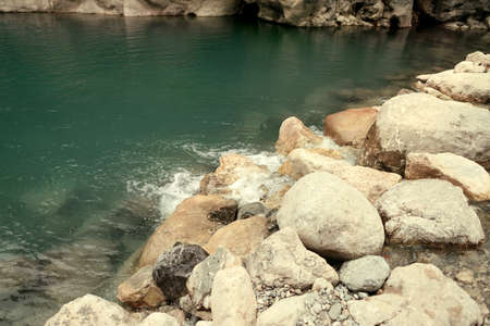 the flow of water with large stones on the riverの写真素材