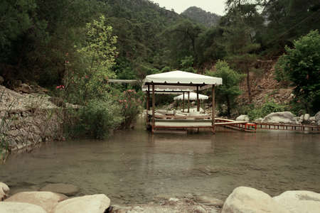 among the mountains on the pond walkway made boards and marqueesの写真素材