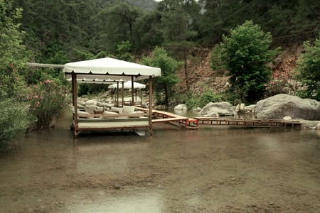 among the mountains on the pond walkway made boards and marqueesの写真素材