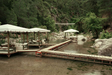 among the mountains on the pond walkway made boards and marqueesの写真素材
