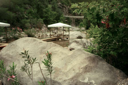 among the mountains on the pond walkway made boards and marqueesの写真素材