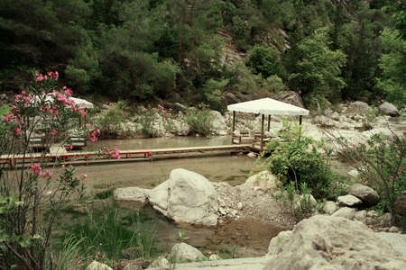among the mountains on the pond walkway made boards and marqueesの写真素材