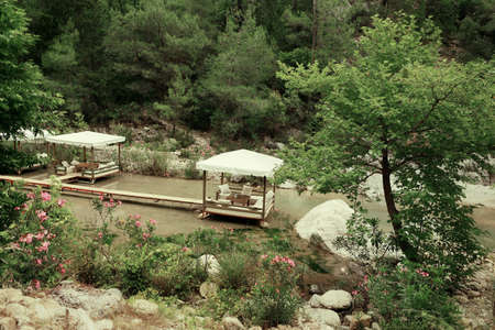 among the mountains on the pond walkway made boards and marqueesの写真素材