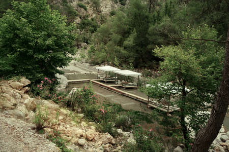 among the mountains on the pond walkway made boards and marqueesの写真素材