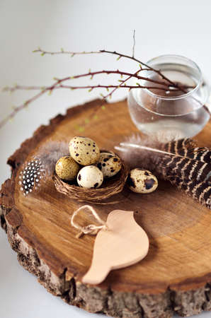 Quail eggs in the bowl on wooden background