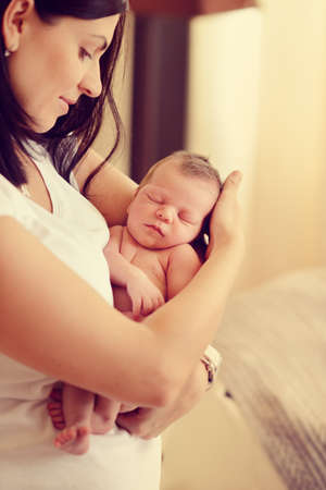 mother with long black hair with a small childの写真素材