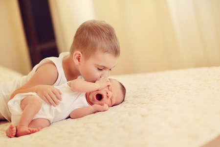 little brother with the sleeping babyの写真素材