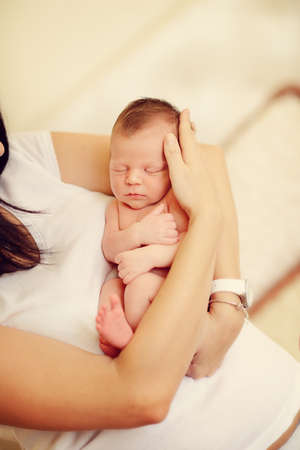 mother with long black hair with a small childの写真素材