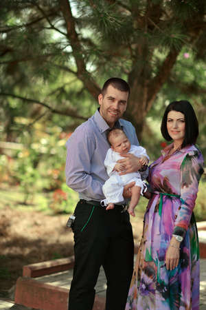 summer day on the nature of a young family with a babyの写真素材