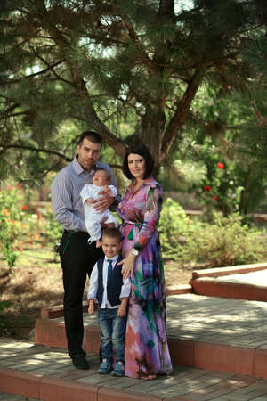 summer day on the nature of a young family with a babyの写真素材