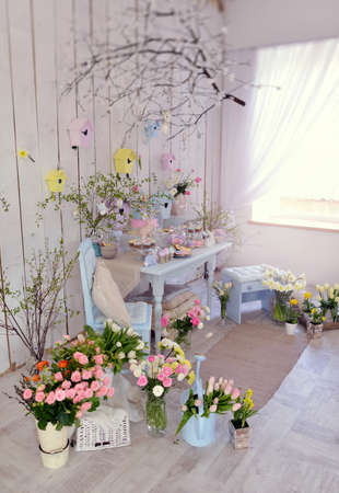 interior decoration of the room on the floor are vases with pink roses and tulipsの写真素材