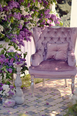 lilac composition on the street under a canopy are vases with bouquets of lilacs and chairの写真素材