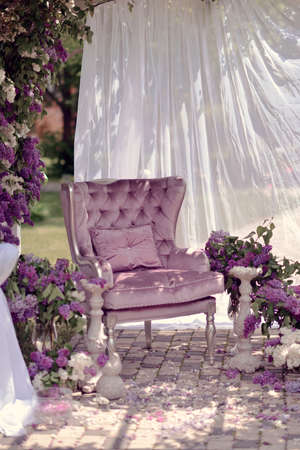 lilac composition on the street under a canopy are vases with bouquets of lilacs and chairの写真素材
