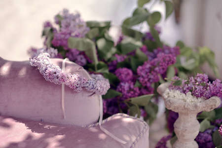 on the background of the church in the window is a vase with a bouquet of lilacsの写真素材